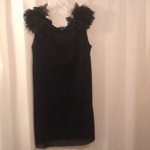 Black dress with faux feather inspired sleeves.